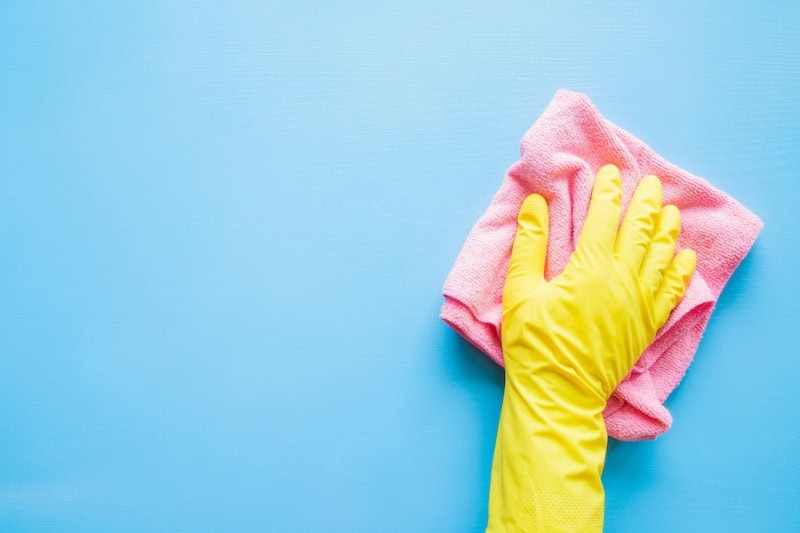 Does an AC Kill Mold? Hand in a yellow rubber glove