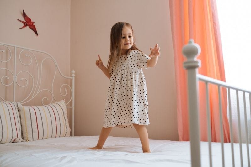 Image of a child standing on a bed. What You Should Know About Air Handlers.
