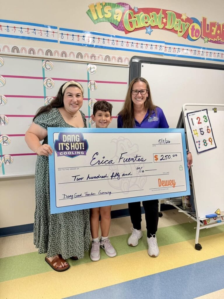 Vanessa Ferrara giving a gift to a local Pompano Beach teacher