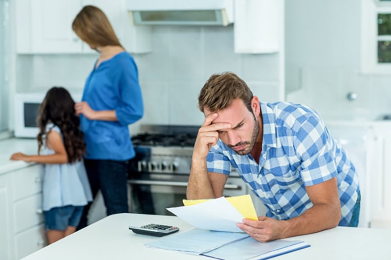 worried man leaning over counter