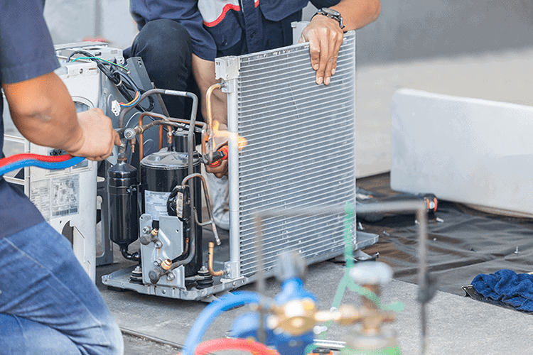 HVAC technicians performing maintenance. What Are the Benefits of Commercial HVAC Maintenance?