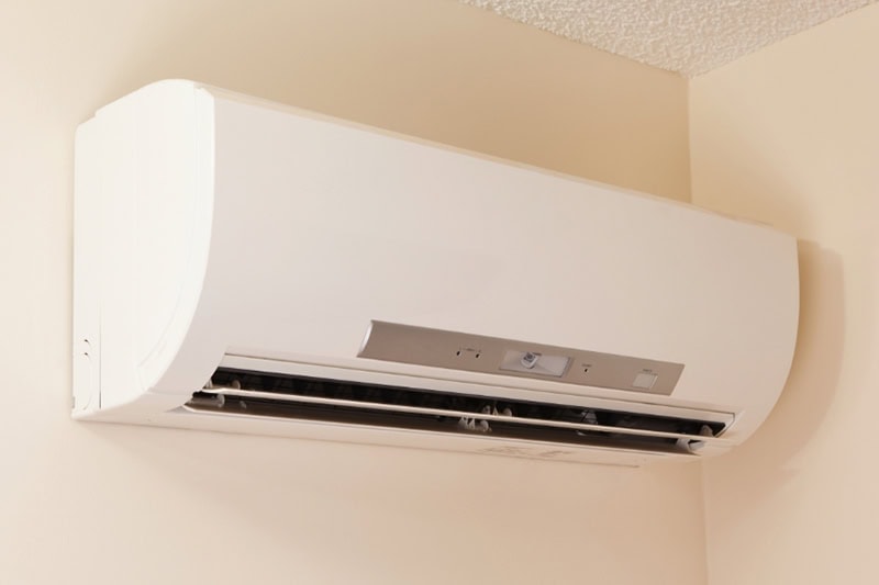 Why Are They Called Ductless Mini Splits? A wall-mount mini-split heating and air conditioning unit installed in a new house. A modern heat pump